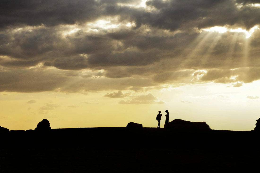 Relationship Karma — two people standing apart in silhouette at dusk