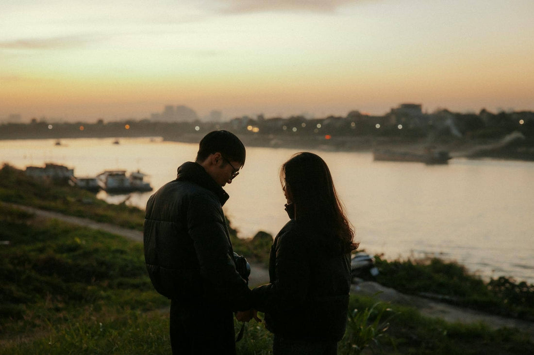 Narcissist and empath attraction — a couple at sunset turned from each other, tension in the space between them