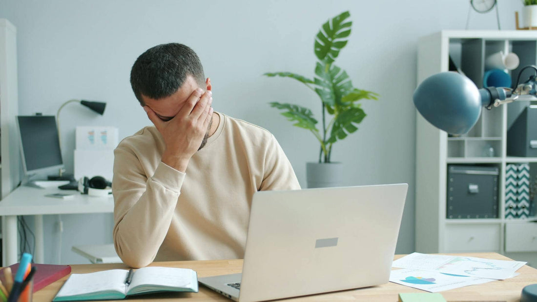 A stressed person at a desk unable to focus — why meditation is not working