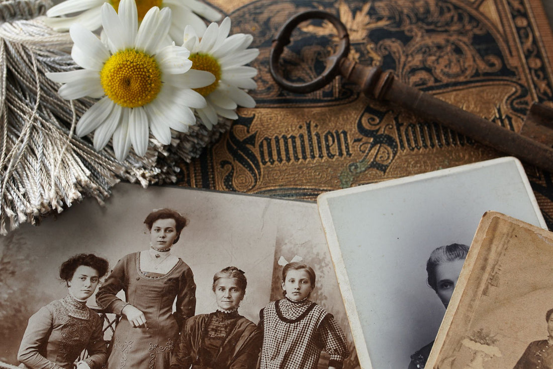 Stack of vintage family photographs, illustrating relationship patterns transmitted across generations